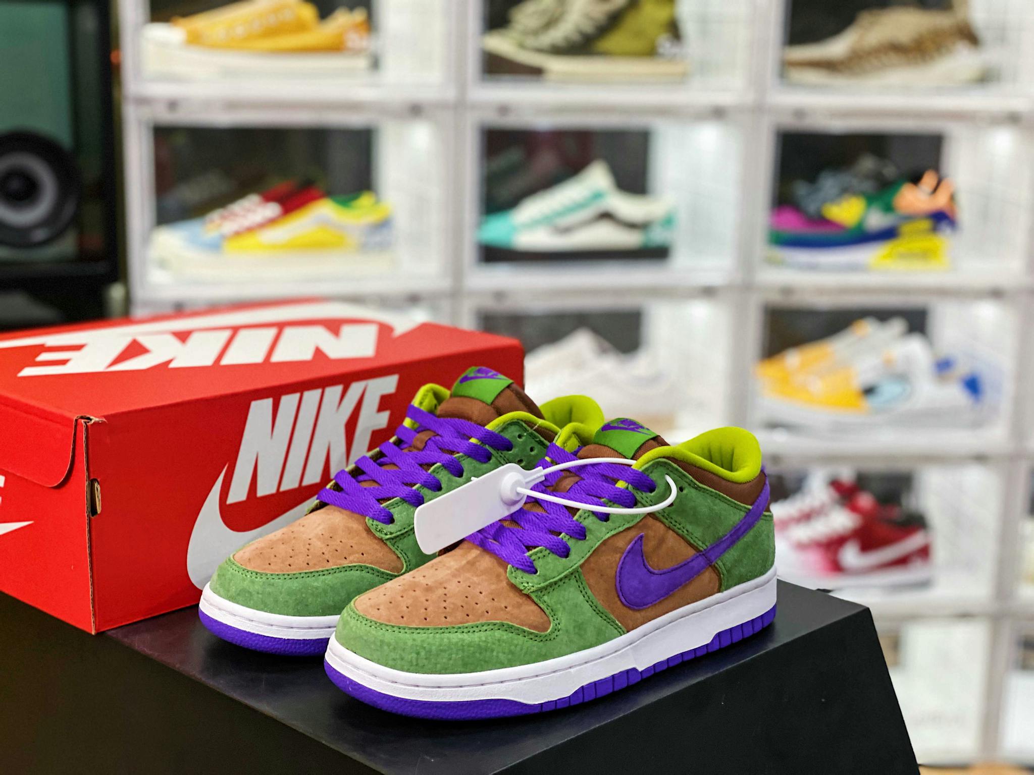 Colorful sneakers with Nike logo displayed in a stylish shoe store with a blurred background.
